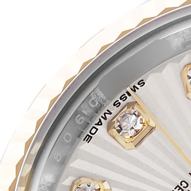 The image shows a close-up angle of the Rolex Datejust 179173 Women's Steel and Gold (two tone) Silver Dial 179173 Women's Steel and Gold (two tone) Silver Dial watch's diamond hour marker, part of the dial, and fluted bezel.