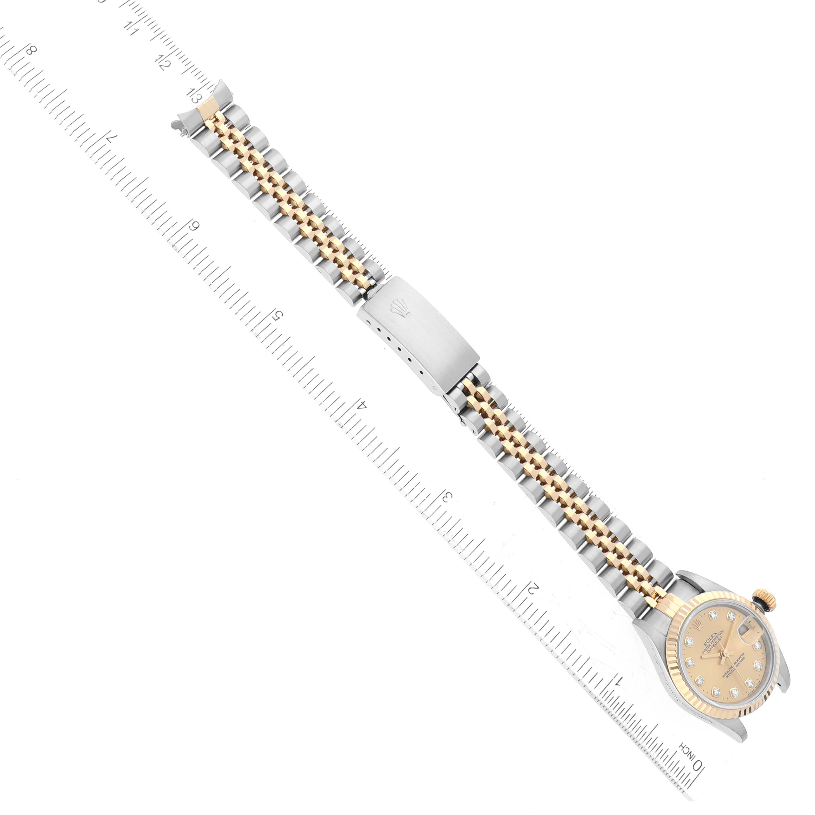 This image shows a Rolex Datejust 69173 Women's Steel and Gold (two tone) Champagne Dial 69173 Women's Steel and Gold (two tone) Champagne Dial model watch at an overhead angle, displaying the face and the full length of the band with a ruler next to it.