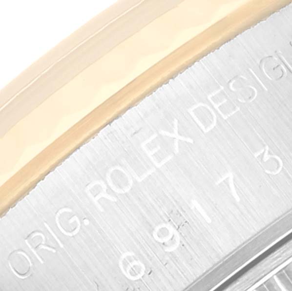 The image shows a close-up of the bezel and engraved case of a Rolex Datejust 69173 Women's Steel and Gold (two tone) Champagne Dial 69173 Women's Steel and Gold (two tone) Champagne Dial watch.