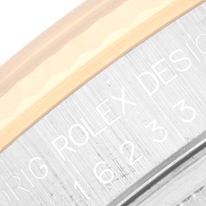 The image shows a close-up angle of the side engraving on the bezel of a Rolex Datejust 16233 Men's Steel and Gold (two tone) Champagne Dial 16233 Men's Steel and Gold (two tone) Champagne Dial watch.
