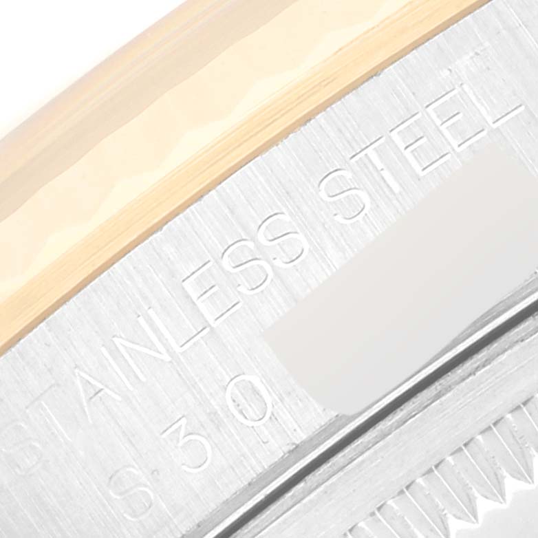 The image shows a close-up of the engraved "STAINLESS STEEL" detail on a Rolex Datejust 16233 Men's Steel and Gold (two tone) Champagne Dial 16233 Men's Steel and Gold (two tone) Champagne Dial watch case.