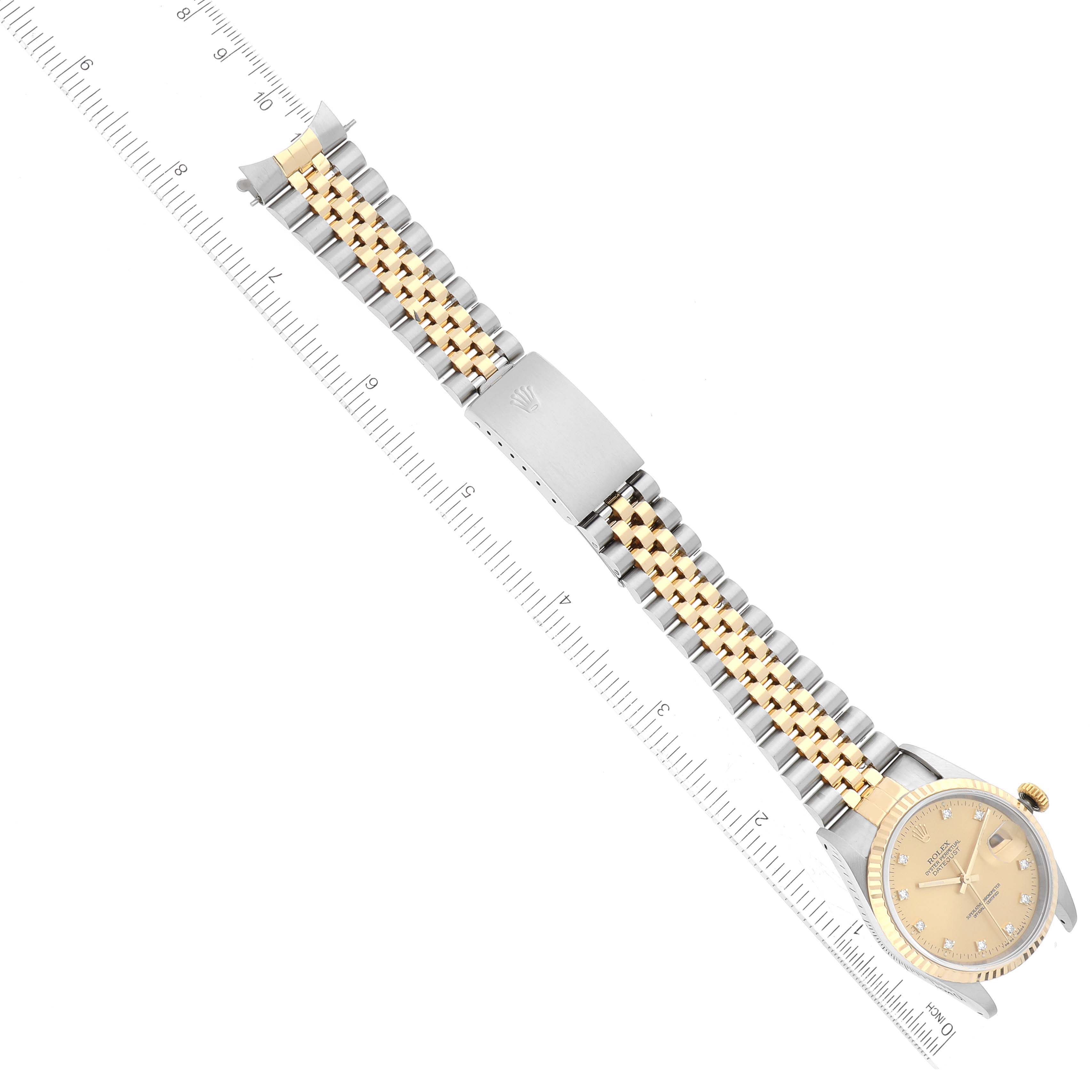 The image shows a Rolex Datejust 16233 Men's Steel and Gold (two tone) Champagne Dial 16233 Men's Steel and Gold (two tone) Champagne Dial watch with a gold and silver jubilee bracelet, positioned horizontally with a ruler for scale.
