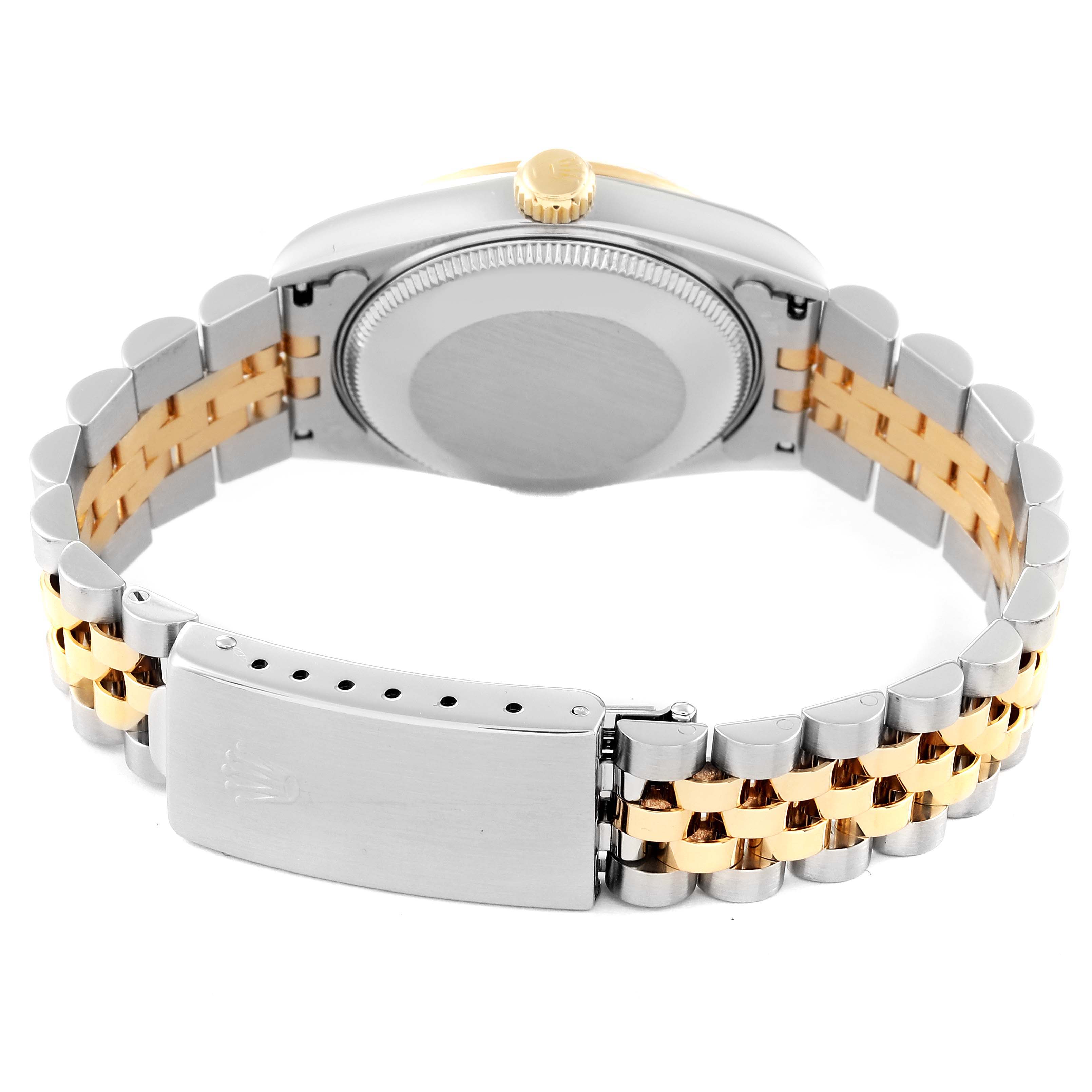 The image shows the back view of a Rolex Mid-Size 68273 Women
s Steel and Gold (two tone) Black Dial 68273 Women
s Steel and Gold (two tone) Black Dial model watch with a two-tone metal bracelet and a closed clasp.