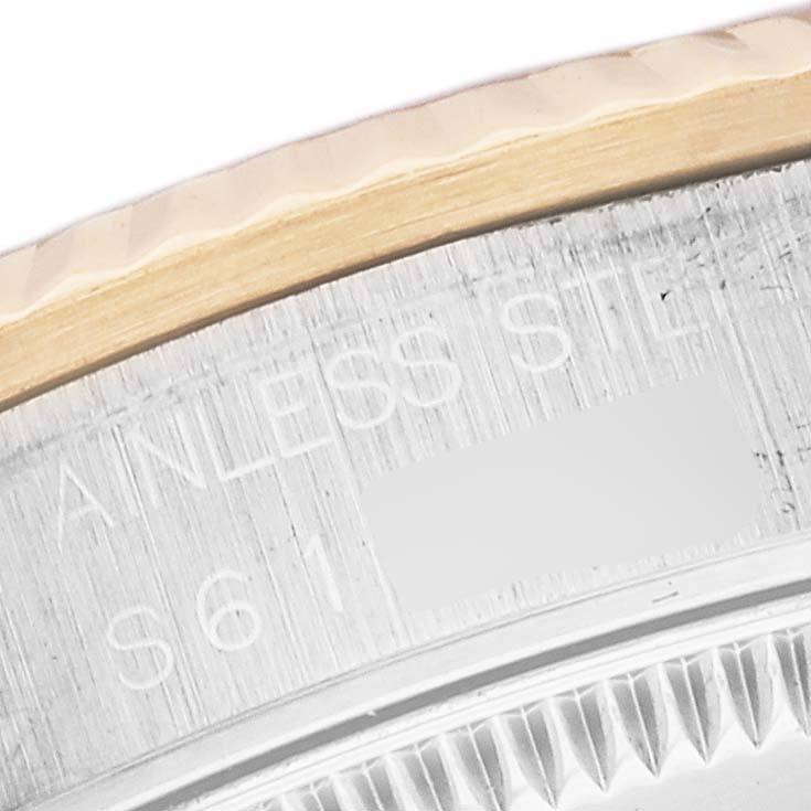 The image shows the side engraving and fluted bezel of a Rolex Mid-Size 68273 Women
s Steel and Gold (two tone) Black Dial 68273 Women
s Steel and Gold (two tone) Black Dial model watch.