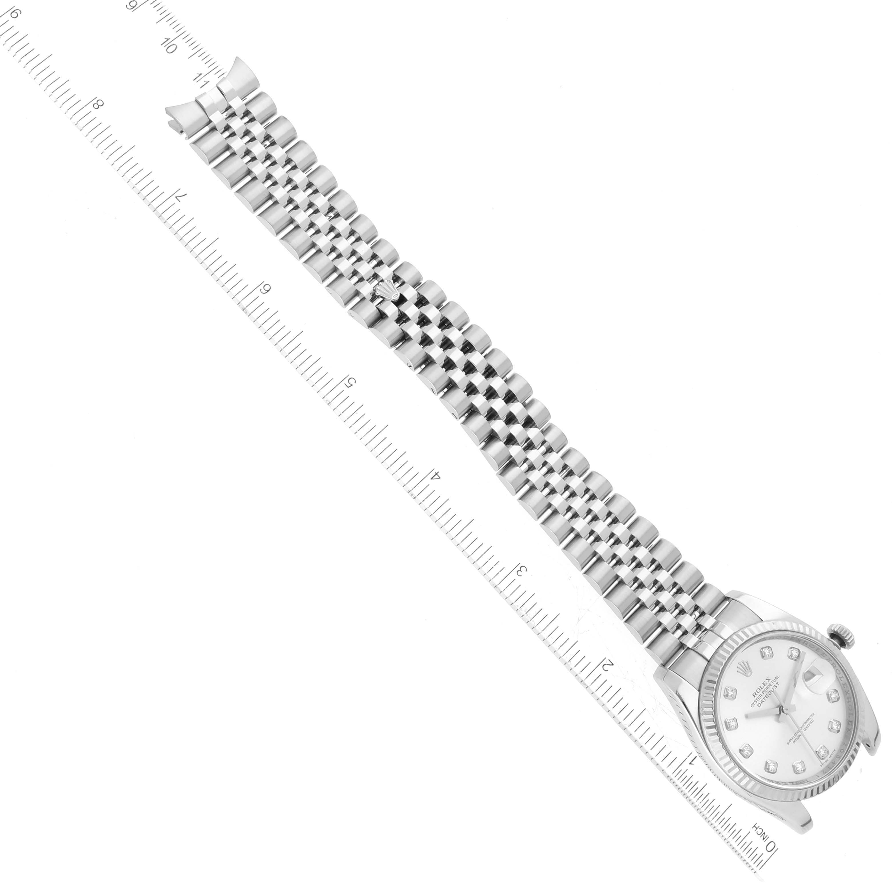 This is a top-down view of a Rolex Datejust 116234 Men's Stainless Steel Silver Dial 116234 Men's Stainless Steel Silver Dial watch, showing its face and full bracelet alongside a ruler.