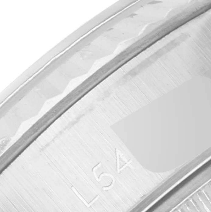 This image shows a close-up of the fluted bezel and inner casing, with part of the serial number, of a Rolex Datejust 69174 Women's Stainless Steel Grey Dial 69174 Women's Stainless Steel Grey Dial watch.