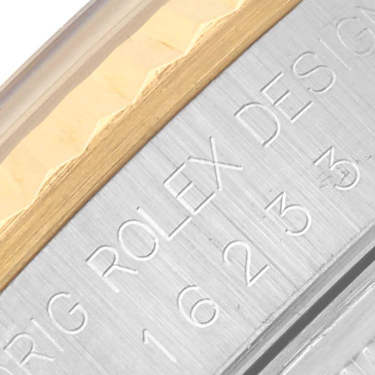 The image shows a close-up of the metal and gold bezel edge with engraved text on the Rolex Datejust 16233 Men's Steel and Gold (two tone) Blue Dial 16233 Men's Steel and Gold (two tone) Blue Dial watch.