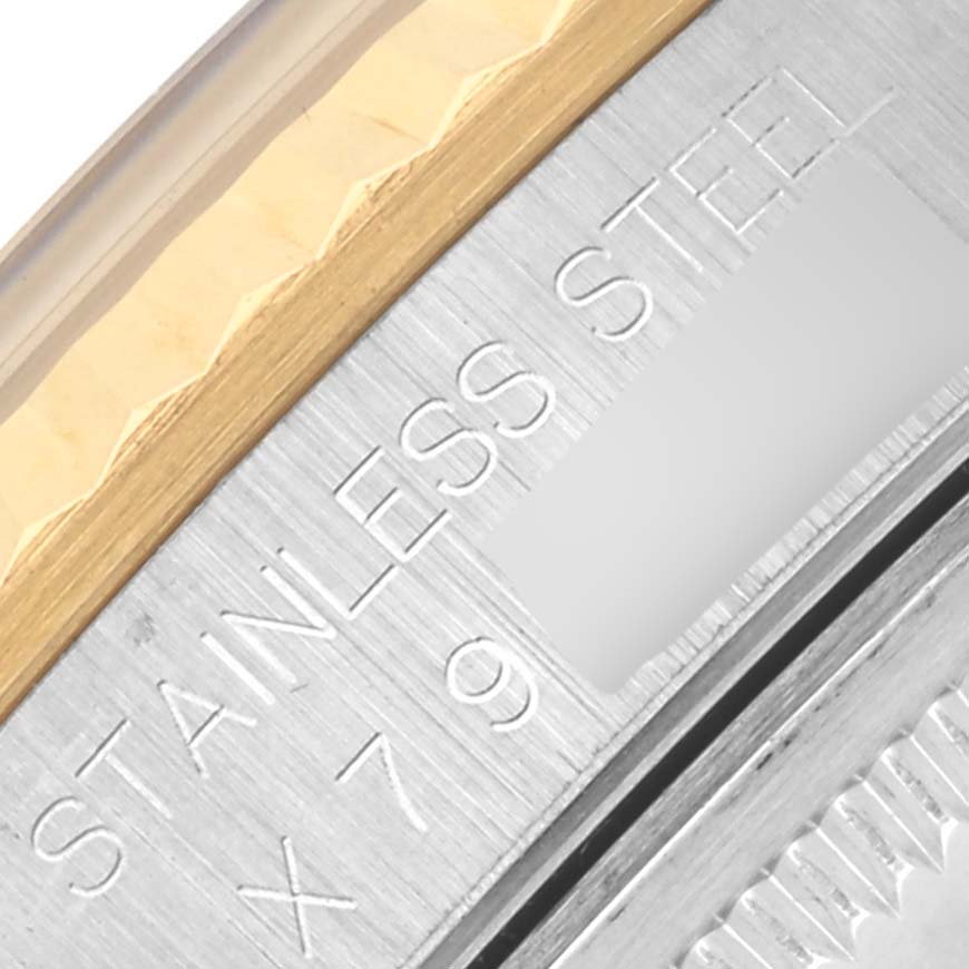 This image shows a close-up of the case edge and bezel of a Rolex Datejust 16233 Men's Steel and Gold (two tone) Blue Dial 16233 Men's Steel and Gold (two tone) Blue Dial, highlighting the "STAINLESS STEEL" engraving.