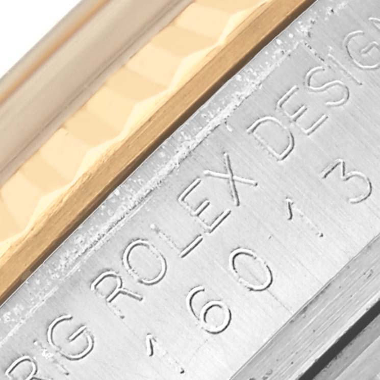 This close-up image shows the side engraving and metal texture of the Rolex Datejust 16013 Men's Steel and Gold (two tone) Champagne Dial 16013 Men's Steel and Gold (two tone) Champagne Dial watch bezel.