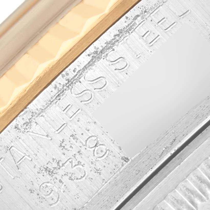 The image shows a close-up of the Rolex Datejust 16013 Men's Steel and Gold (two tone) Champagne Dial 16013 Men's Steel and Gold (two tone) Champagne Dial's bezel and part of the fluted edge.