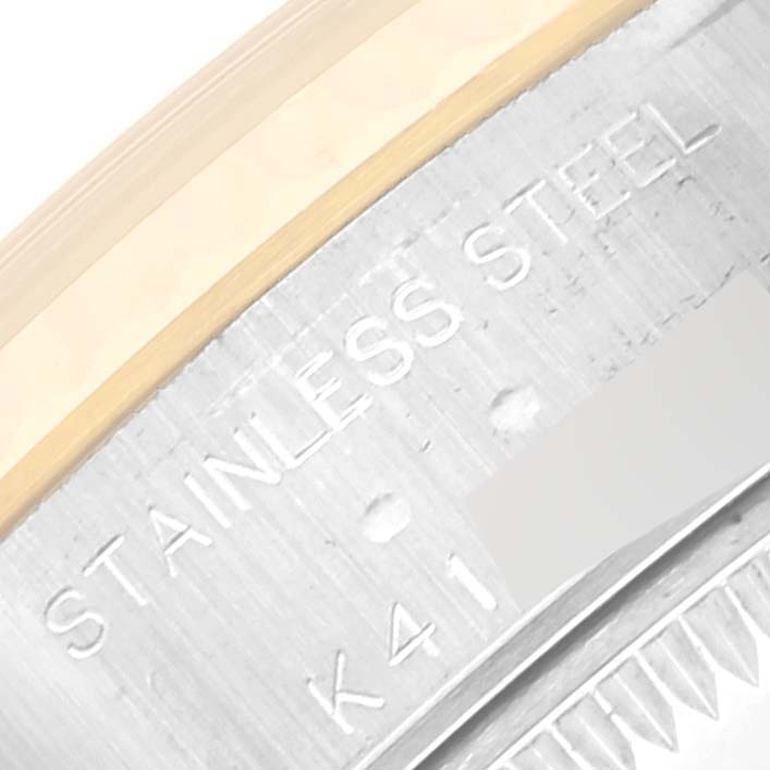 The image shows a close-up of the outer rim of a Rolex Datejust 79173 Women's Steel and Gold (two tone) White Dial 79173 Women's Steel and Gold (two tone) White Dial watch, highlighting the stainless steel and engravings.