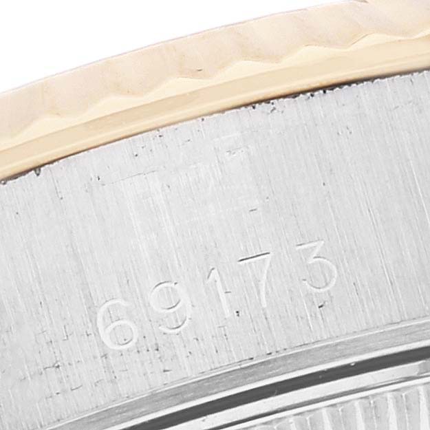 This close-up image shows part of the bezel and casing with the Rolex Datejust 69173 Women's Steel and Gold (two tone) White Dial 69173 Women's Steel and Gold (two tone) White Dial model number 69173 engraved.