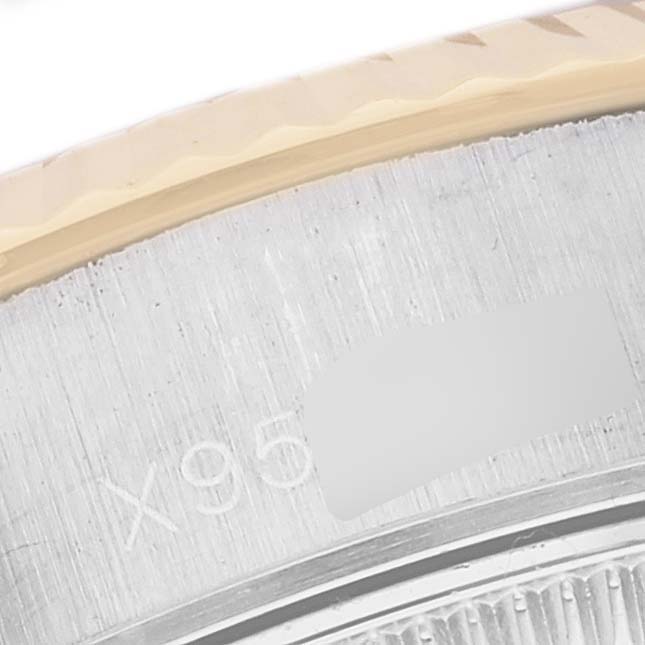 This close-up image shows part of the bezel and case of a Rolex Datejust 69173 Women's Steel and Gold (two tone) White Dial 69173 Women's Steel and Gold (two tone) White Dial watch.