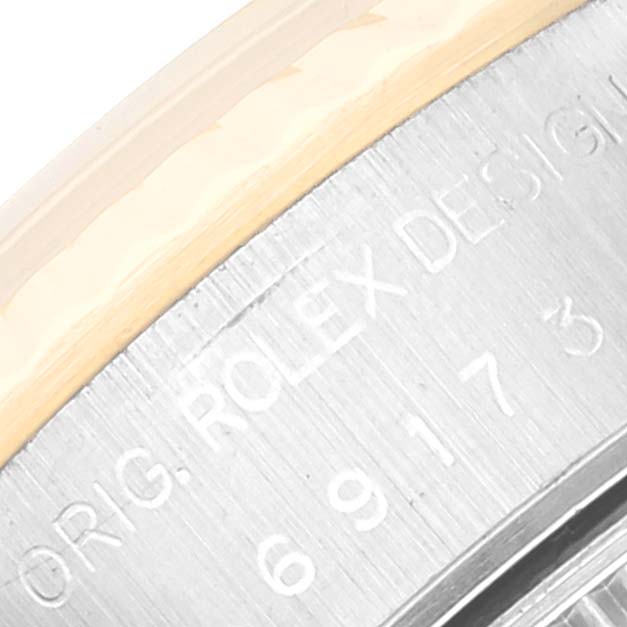 The image shows a close-up of the engraved text and serial number on the case of a Rolex Datejust 69173 Women's Steel and Gold (two tone) White Dial 69173 Women's Steel and Gold (two tone) White Dial watch.