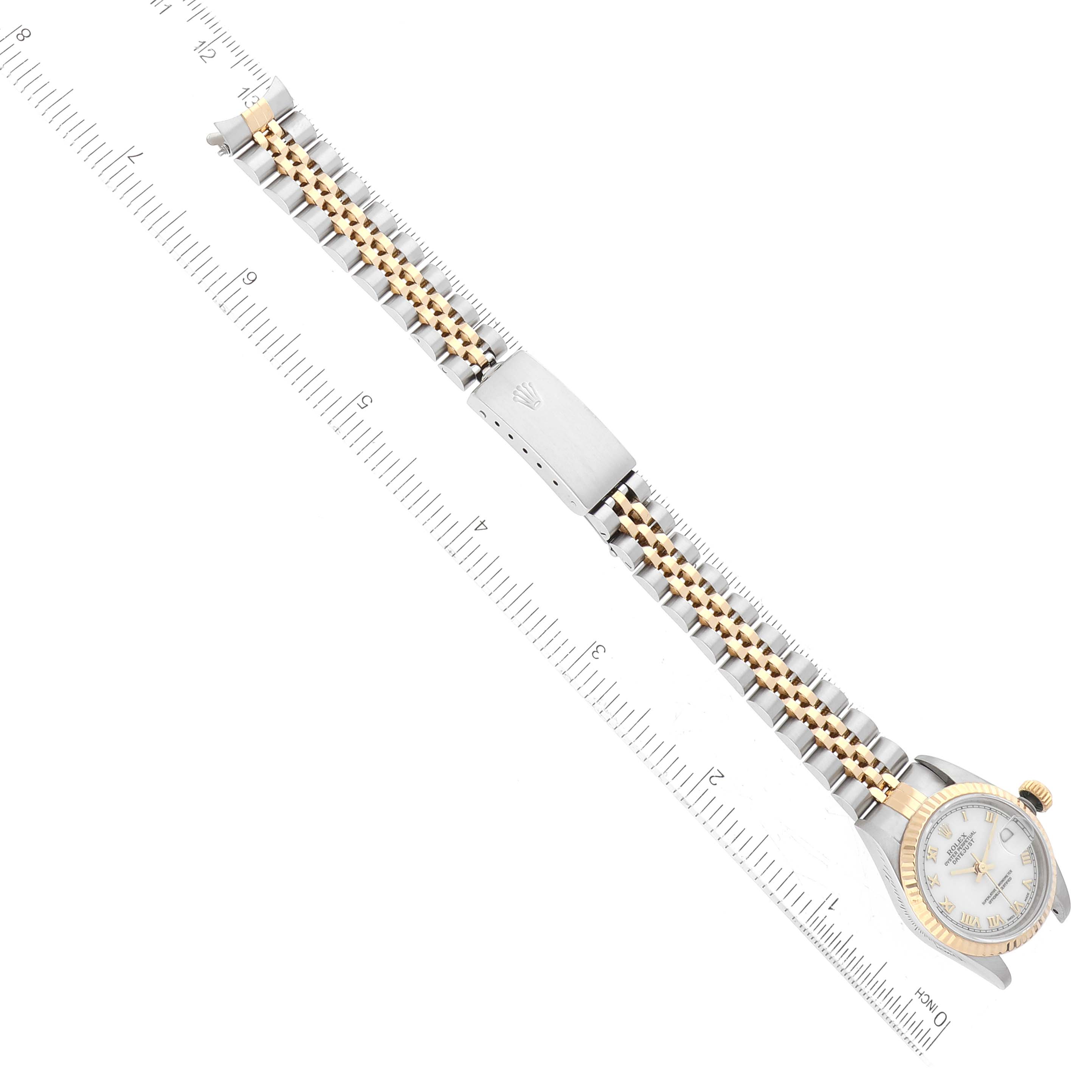 The image shows a top view of a Rolex Datejust 69173 Women's Steel and Gold (two tone) White Dial 69173 Women's Steel and Gold (two tone) White Dial watch with a two-tone bracelet and a caliper measuring the band's length.