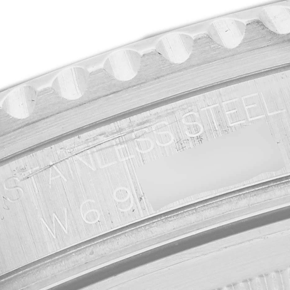 The image shows a close-up of the bezel and serial number engraving on a Rolex GMT-Master 16710 Men
s Stainless Steel Black Dial 16710 Men
s Stainless Steel Black Dial watch.