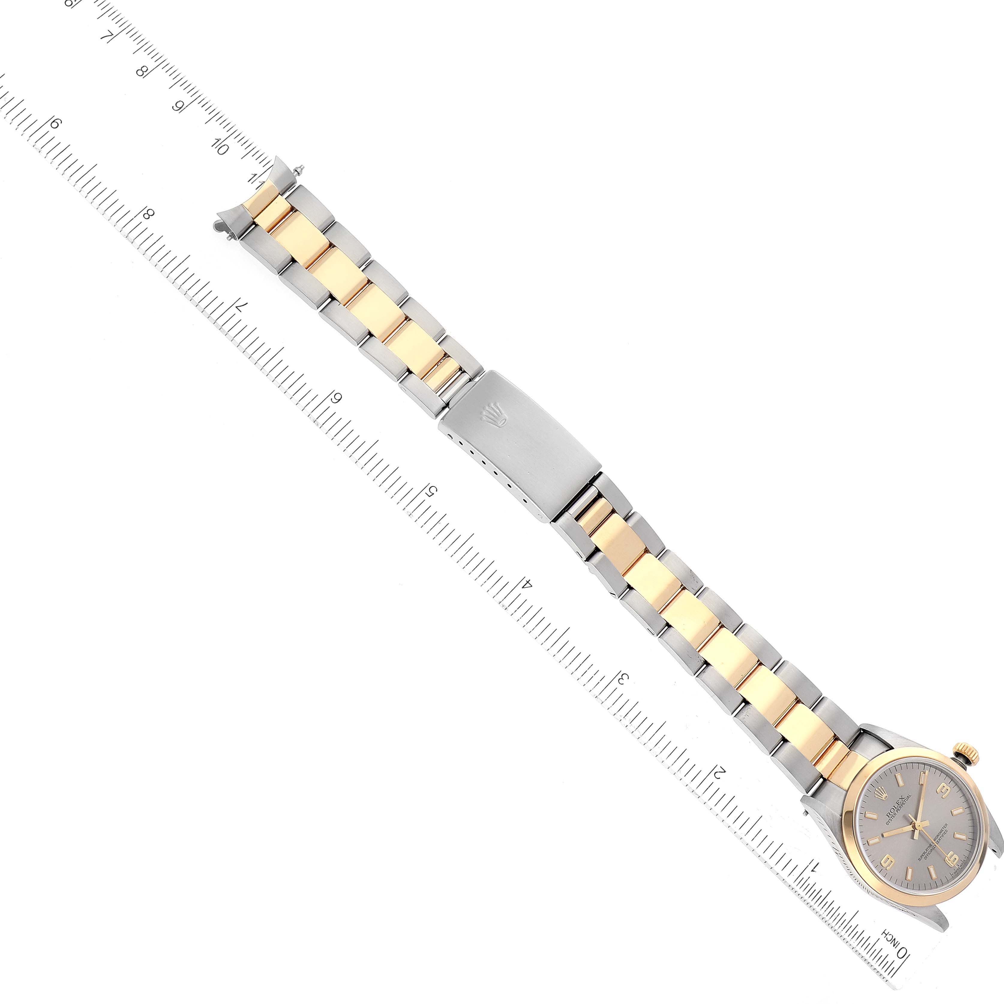 The image shows a top-down view of a Mid-Size Rolex watch, displaying its two-tone metal band and the watch face.