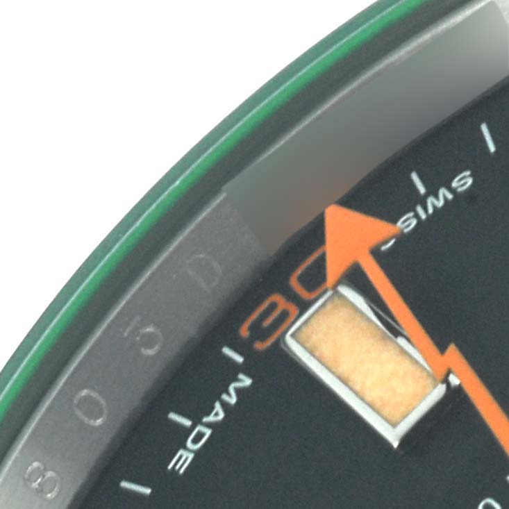 The image shows a close-up of the dial edge and orange second hand of a Rolex Milgauss 116400GV Men's Stainless Steel Black Dial 116400GV Men's Stainless Steel Black Dial watch.