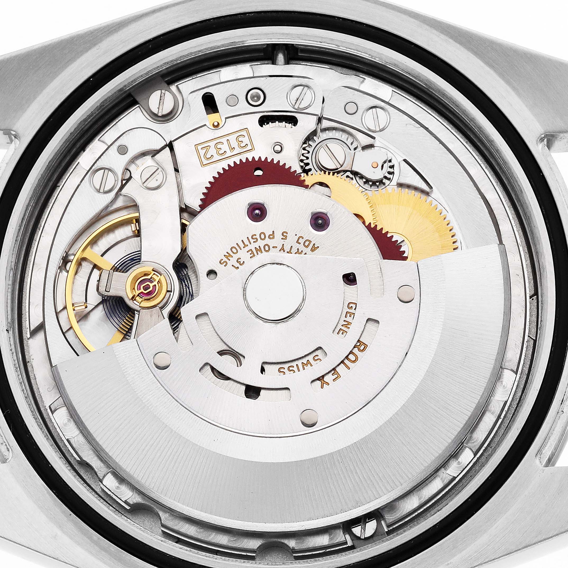 The image shows the movement mechanism of a Rolex Oyster Perpetual 114300 Men's Stainless Steel Grey Dial watch from the back, revealing gears and intricate components.