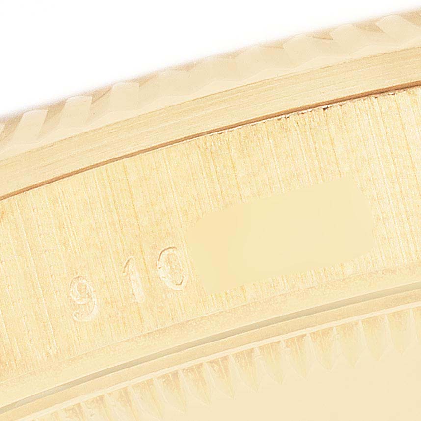 This image shows a close-up of the bezel and partially obscured serial number of the Rolex President 68278G Women's Yellow Gold Champagne Dial 68278G Women's Yellow Gold Champagne Dial model.