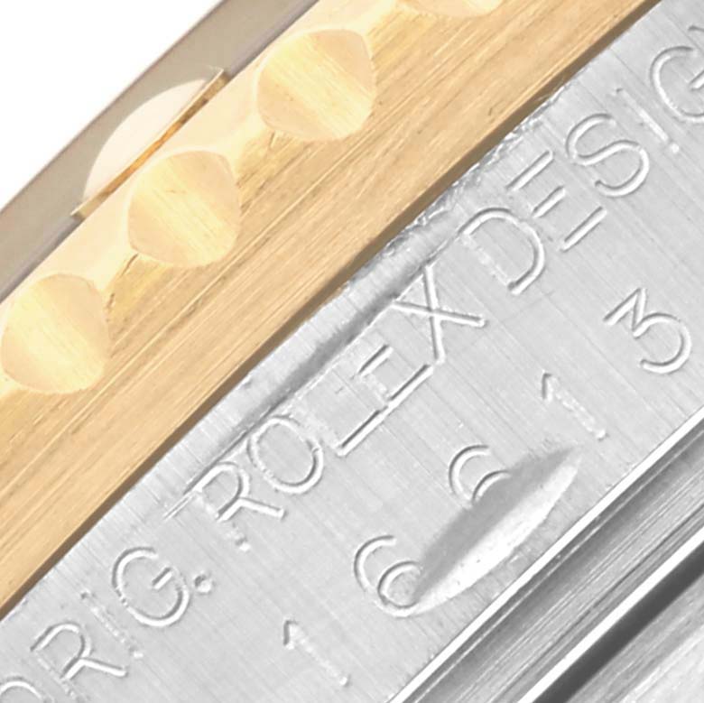 This image shows a close-up of the engraved edge and bezel of a Rolex Submariner 16613 Men's Steel and Gold (two tone) Blue Dial 16613 Men's Steel and Gold (two tone) Blue Dial.