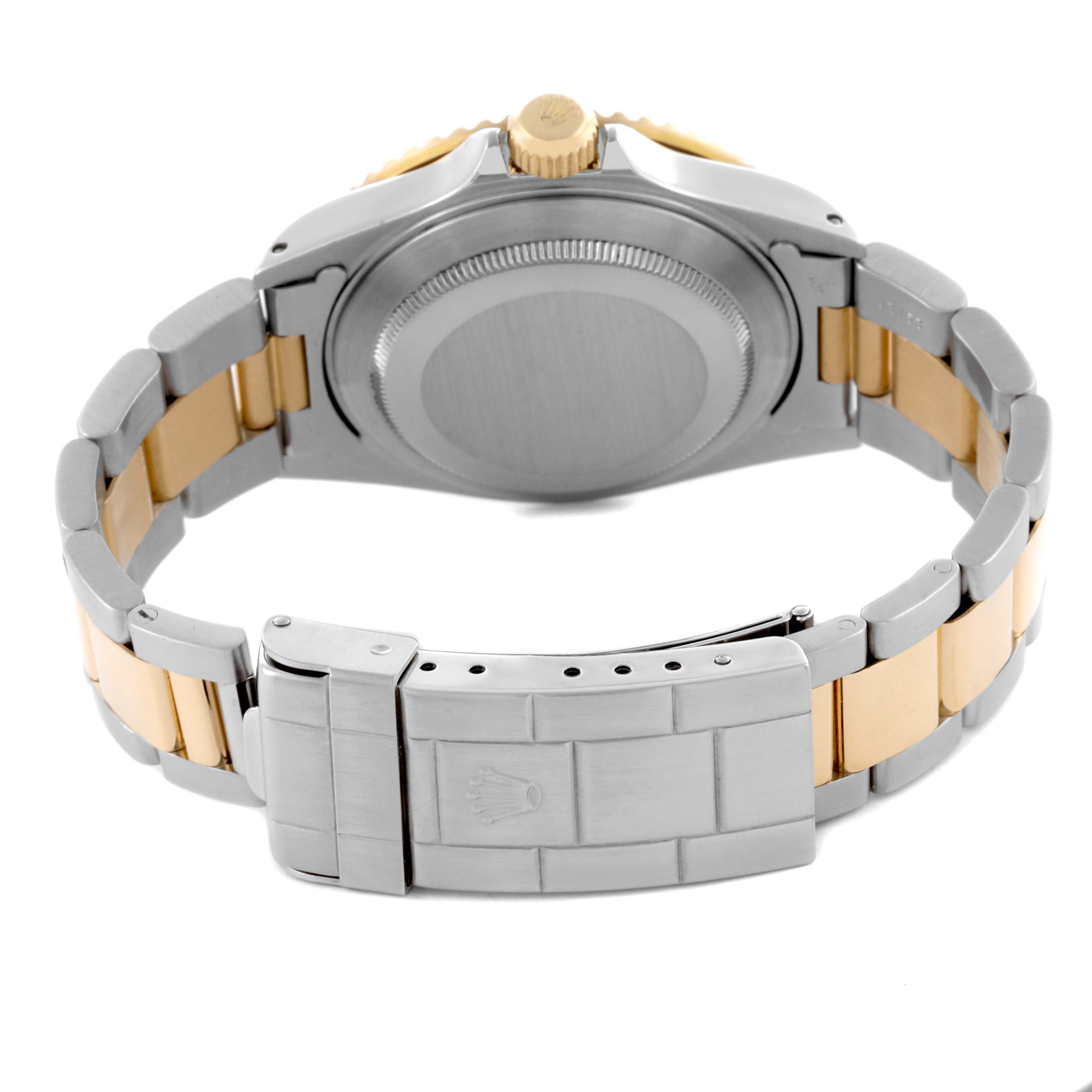 The image shows the back view of a Rolex Submariner 16613 Men's Steel and Gold (two tone) Blue Dial 16613 Men's Steel and Gold (two tone) Blue Dial, highlighting the case back and bracelet clasp.