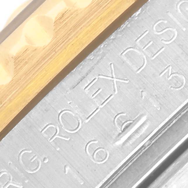 The image shows a close-up of the bezel edge and engraved side of a Rolex Submariner 16613 Men's Steel and Gold (two tone) Blue Dial 16613 Men's Steel and Gold (two tone) Blue Dial watch.