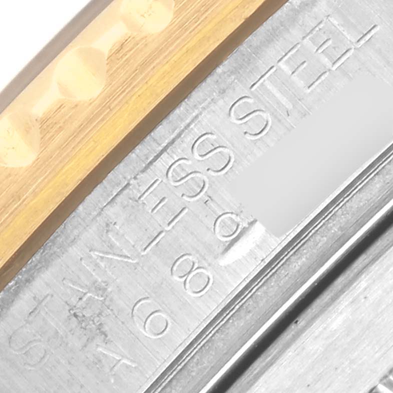 The image shows a close-up of the metallic inner engraved parts of a Rolex Submariner 16613 Men's Steel and Gold (two tone) Blue Dial 16613 Men's Steel and Gold (two tone) Blue Dial watch bezel.