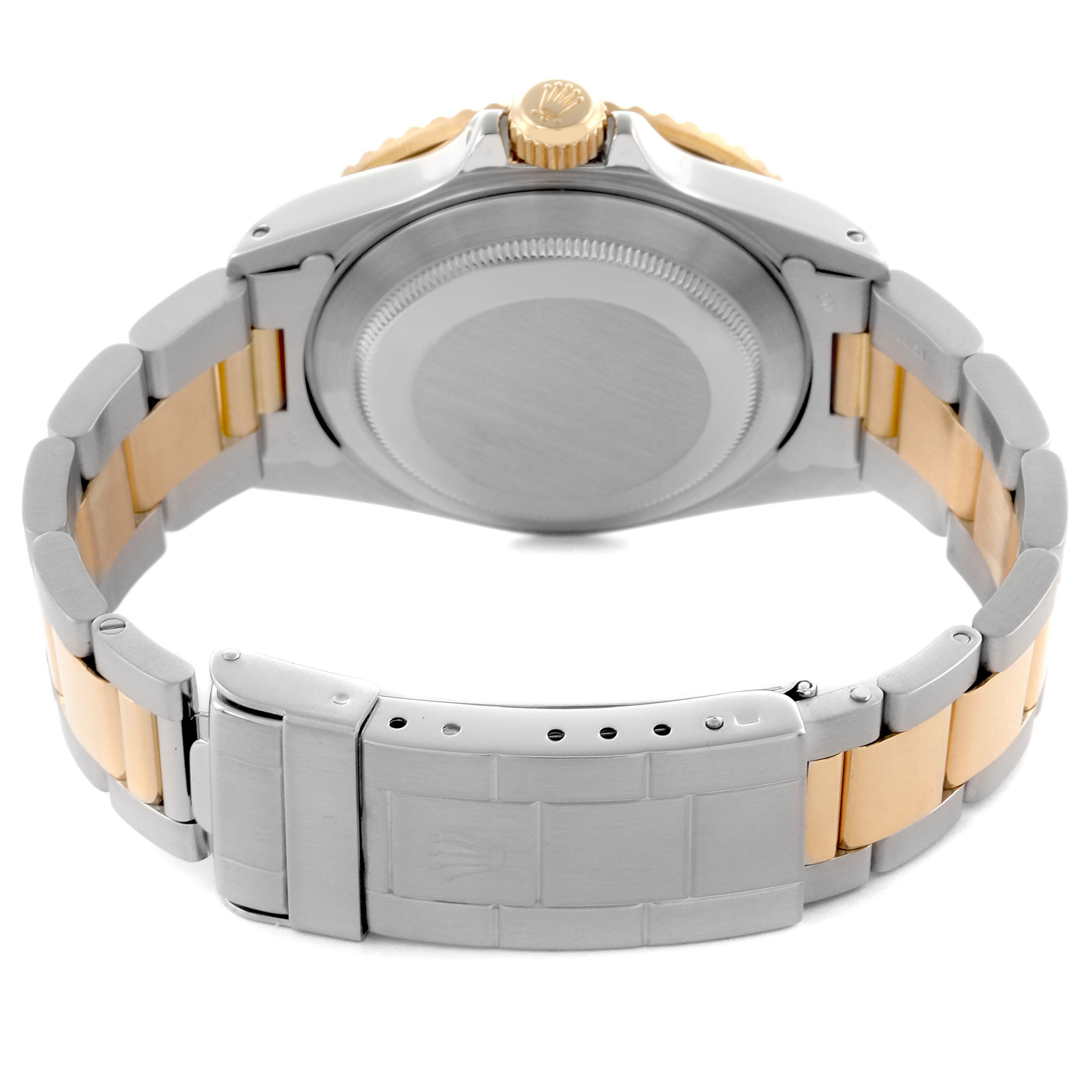 The image shows the back of a Rolex Submariner 16803 Men's Steel and Gold (two tone) Blue Dial 16803 Men's Steel and Gold (two tone) Blue Dial watch, highlighting the case back and bracelet clasp.