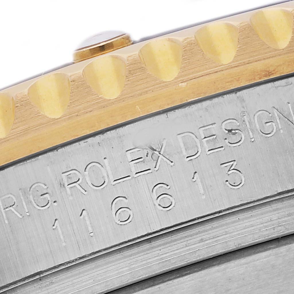 The image shows a close-up of the bezel and engraved model number of a Rolex Submariner 116613LB Men's Steel and Gold (two tone) Blue Dial 116613LB Men's Steel and Gold (two tone) Blue Dial watch.