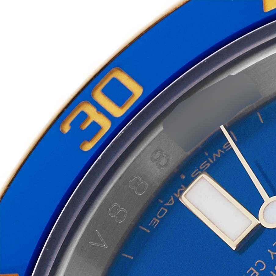The image shows a close-up of the Rolex Submariner 116613LB Men's Steel and Gold (two tone) Blue Dial 116613LB Men's Steel and Gold (two tone) Blue Dial's blue bezel and partial dial, focusing on the "30" marking and one hand.