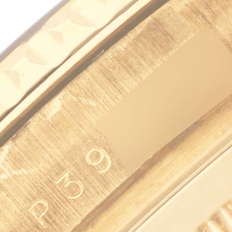 The image shows a close-up of the bezel and engraved details on a Rolex Yacht-Master 16628 Men's Yellow Gold White Dial 16628 Men's Yellow Gold White Dial watch.