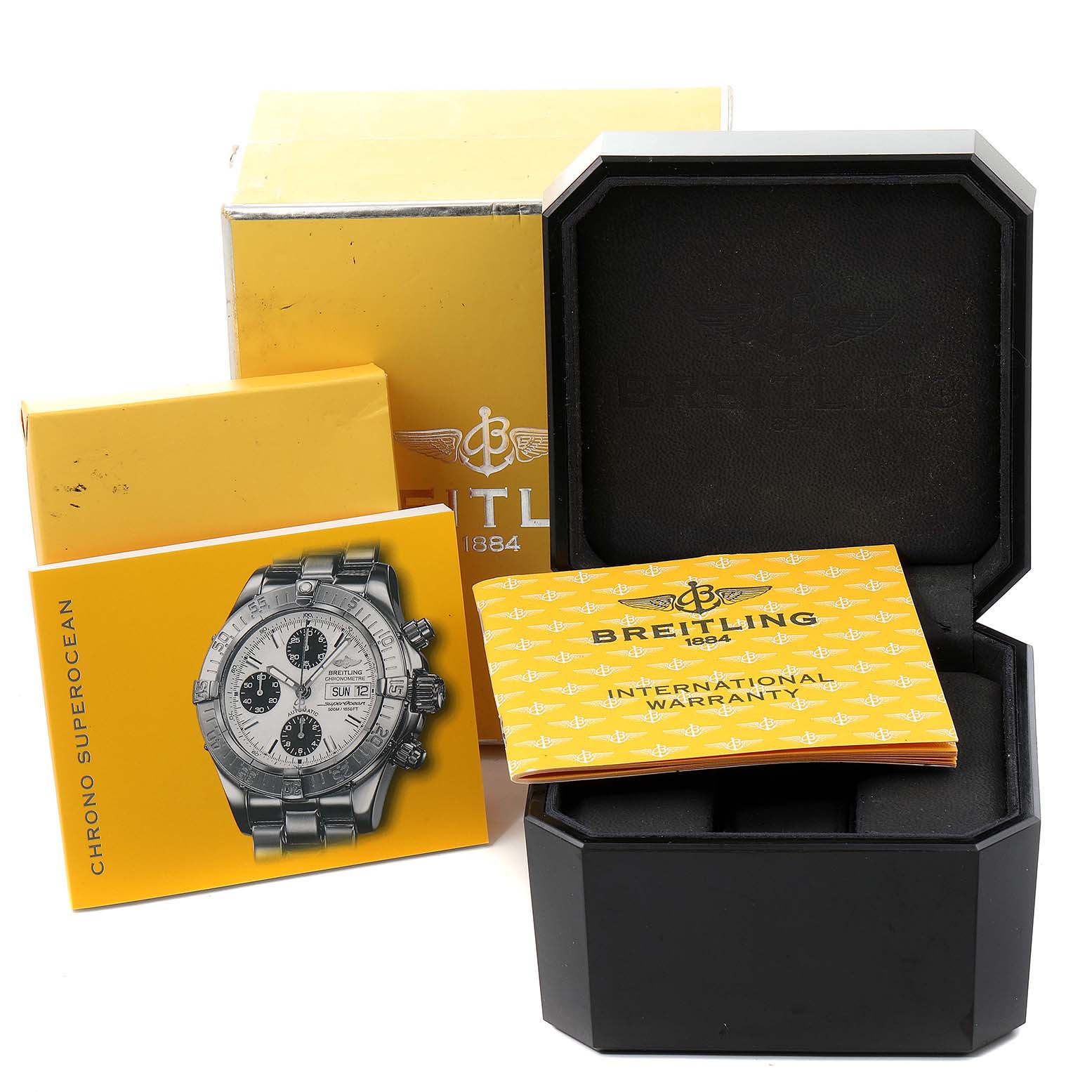 The image shows accessories for a Breitling Superocean A13340 Men's Stainless Steel Blue Dial A13340 Men's Stainless Steel Blue Dial watch, including its box, manual, and international warranty card.
