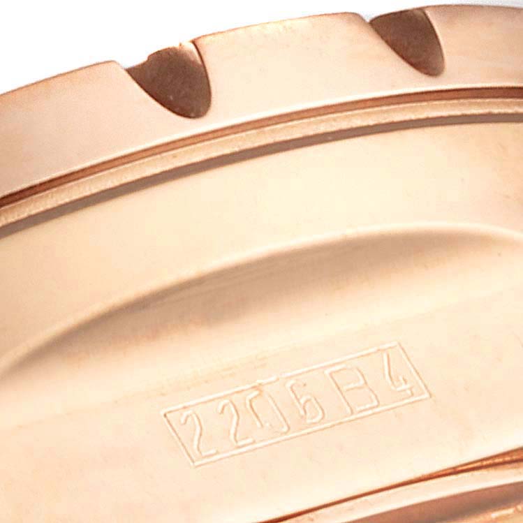 This close-up image shows the partial bezel and engraved serial number of the Breitling Chronomatic H22360 Men's Rose Gold Black Dial H22360 Men's Rose Gold Black Dial model watch.