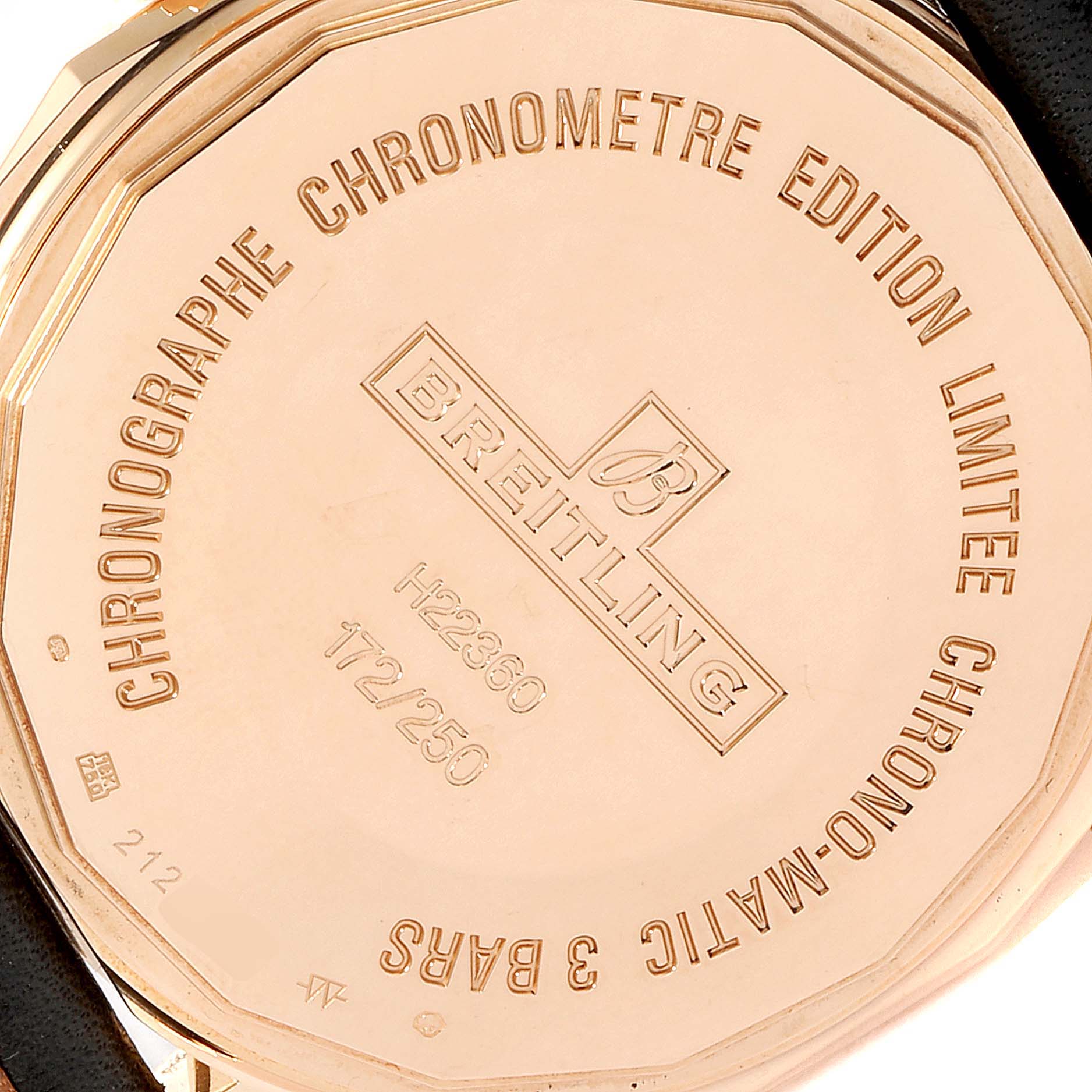 This image shows the case back of a Breitling Chronomatic H22360 Men's Rose Gold Black Dial H22360 Men's Rose Gold Black Dial watch, highlighting its engravings and serial numbers.