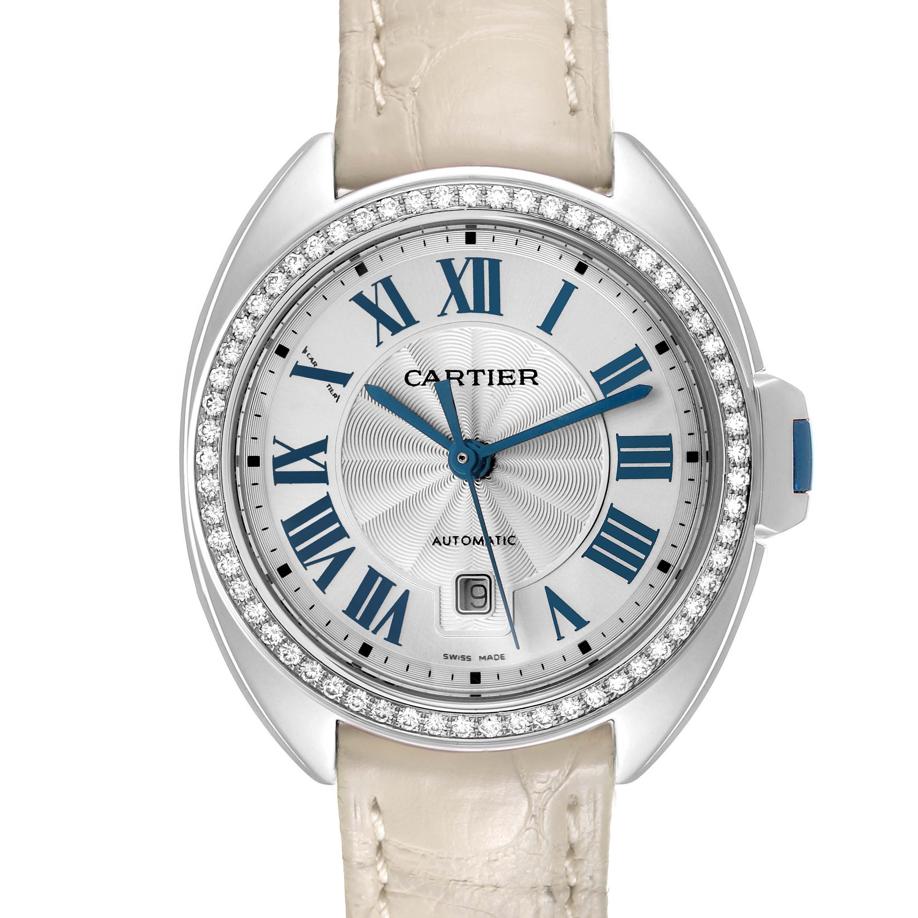 The image shows a Cartier Cle W4CL0005 Women's Stainless Steel Silver Dial watch from a top view, highlighting the Roman numeral dial, diamond bezel, and white strap.
