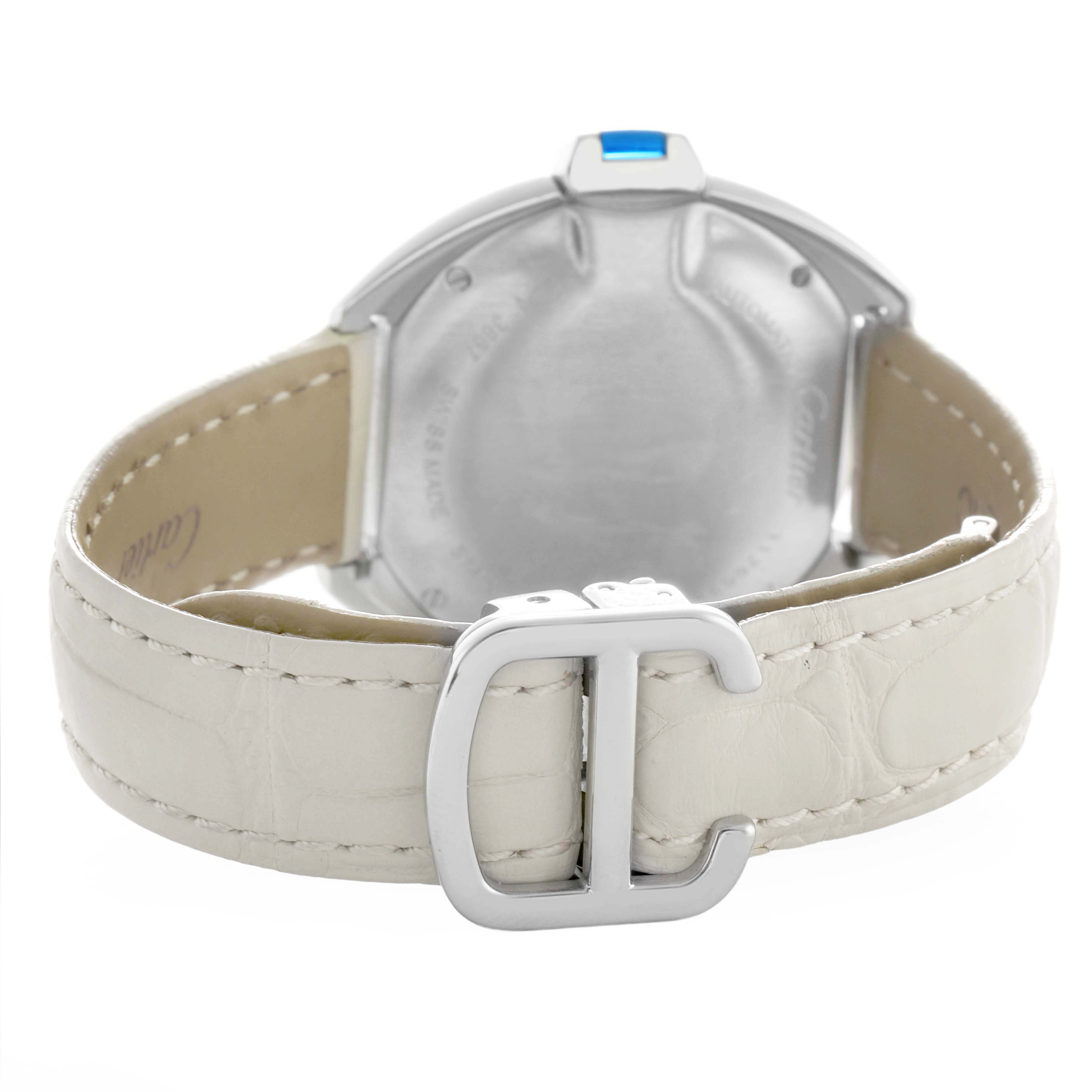 The image shows the back of a Cartier Clé watch, focusing on its caseback, strap, and buckle.