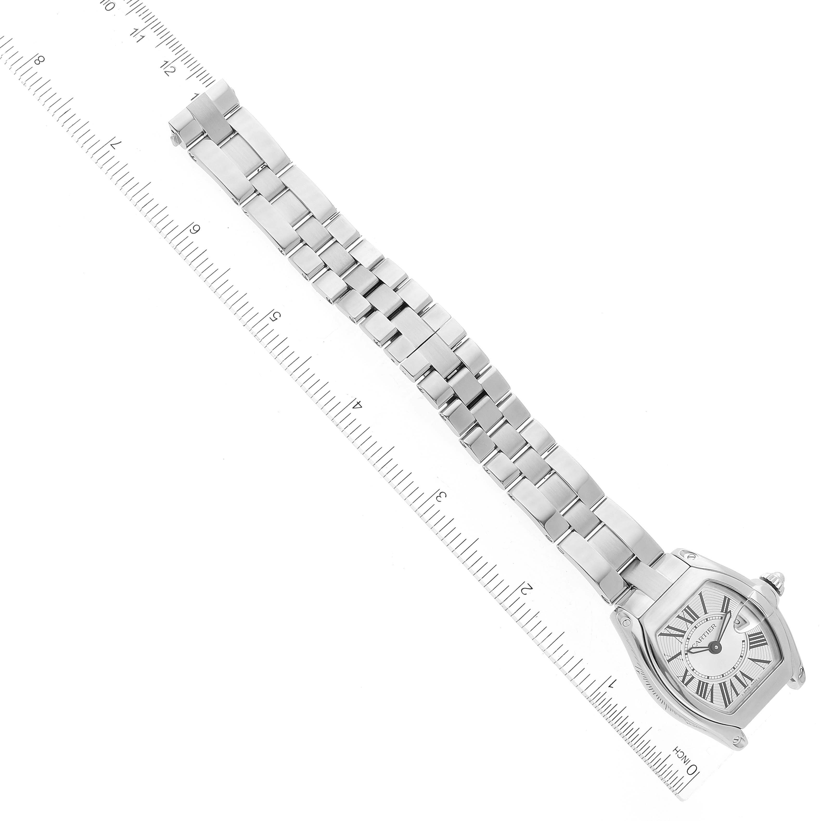 The image shows the front view of a Cartier Roadster W62016V3 Women's Stainless Steel Silver Dial W62016V3 Women's Stainless Steel Silver Dial watch with its metal bracelet and a ruler for scale.