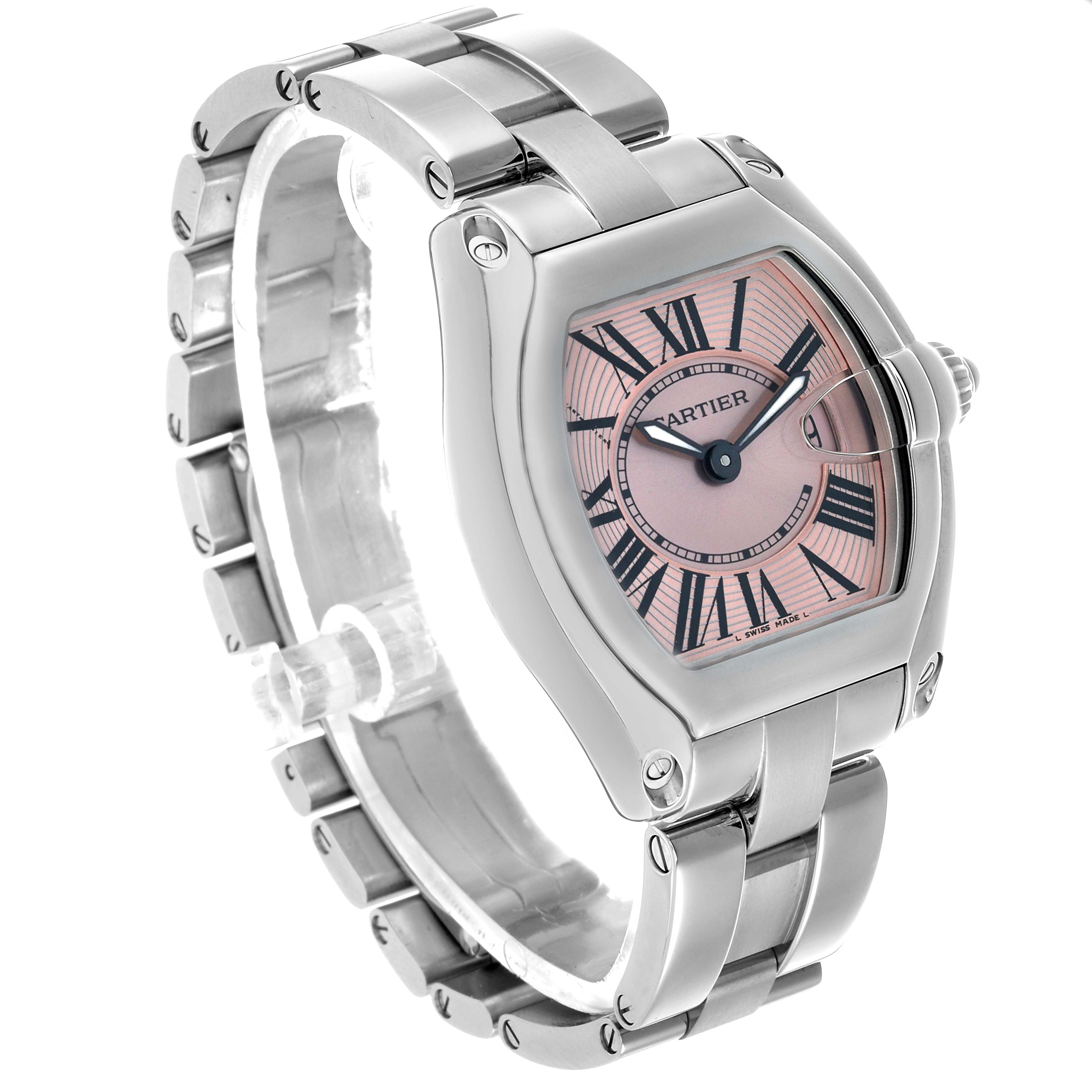 The Cartier Roadster W62017V3 Women's Stainless Steel Pink Dial watch is shown at an oblique angle, highlighting its face, bezel, and bracelet.