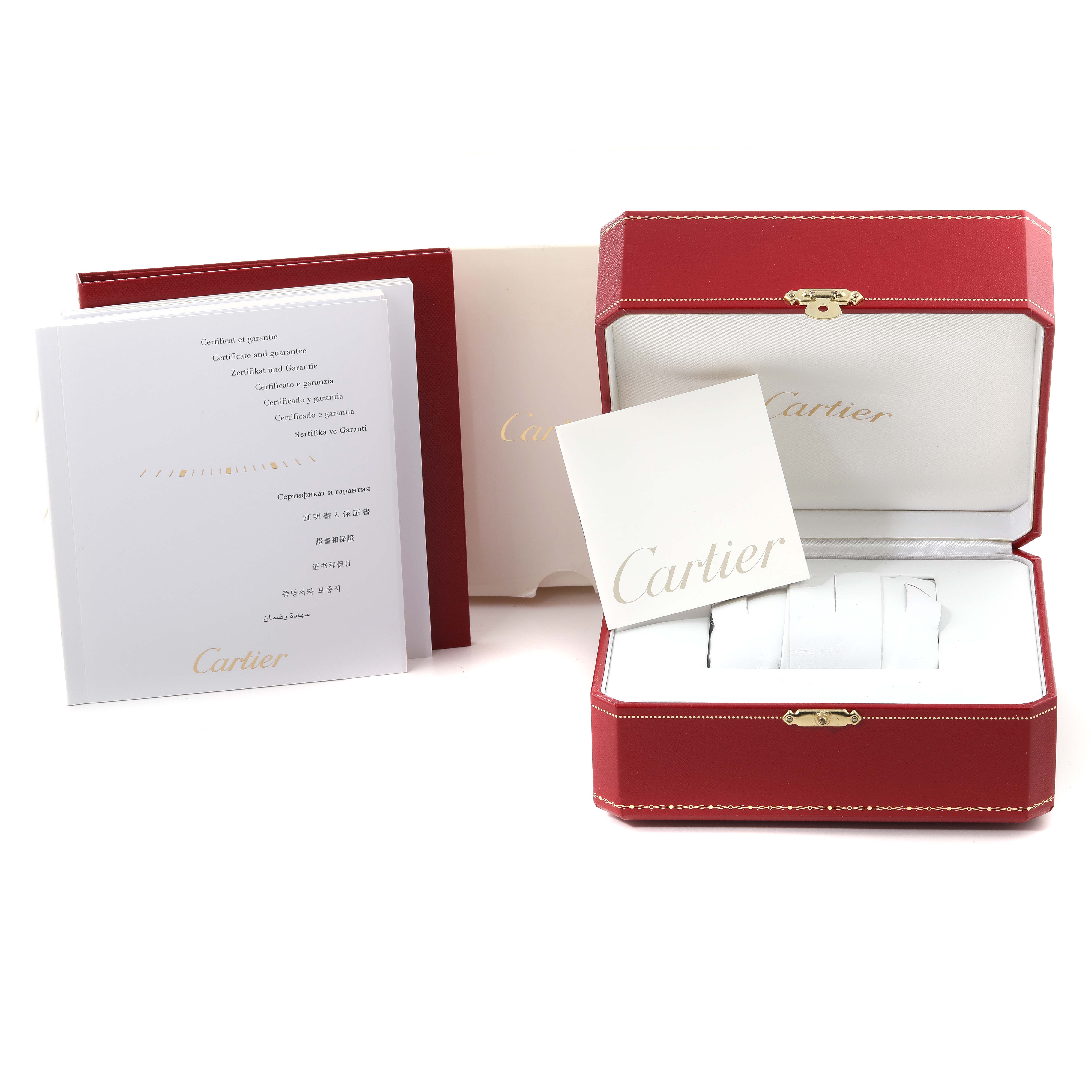 The image shows the packaging, warranty cards, and instruction manuals for a Cartier Tank Anglaise W5310036 Women
s Steel and Gold (two tone) Silver Dial W5310036 Women
s Steel and Gold (two tone) Silver Dial model watch.