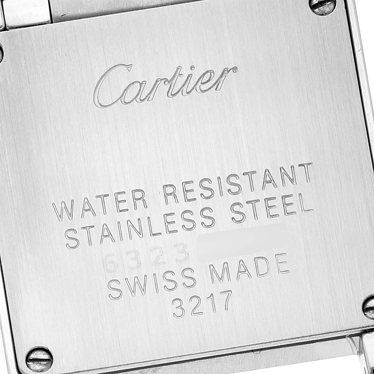 This is a close-up view of the back case of the Cartier Tank Francaise W4TA0008 Women's Stainless Steel Silver Dial W4TA0008 Women's Stainless Steel Silver Dial watch, showing engraved text and screws.