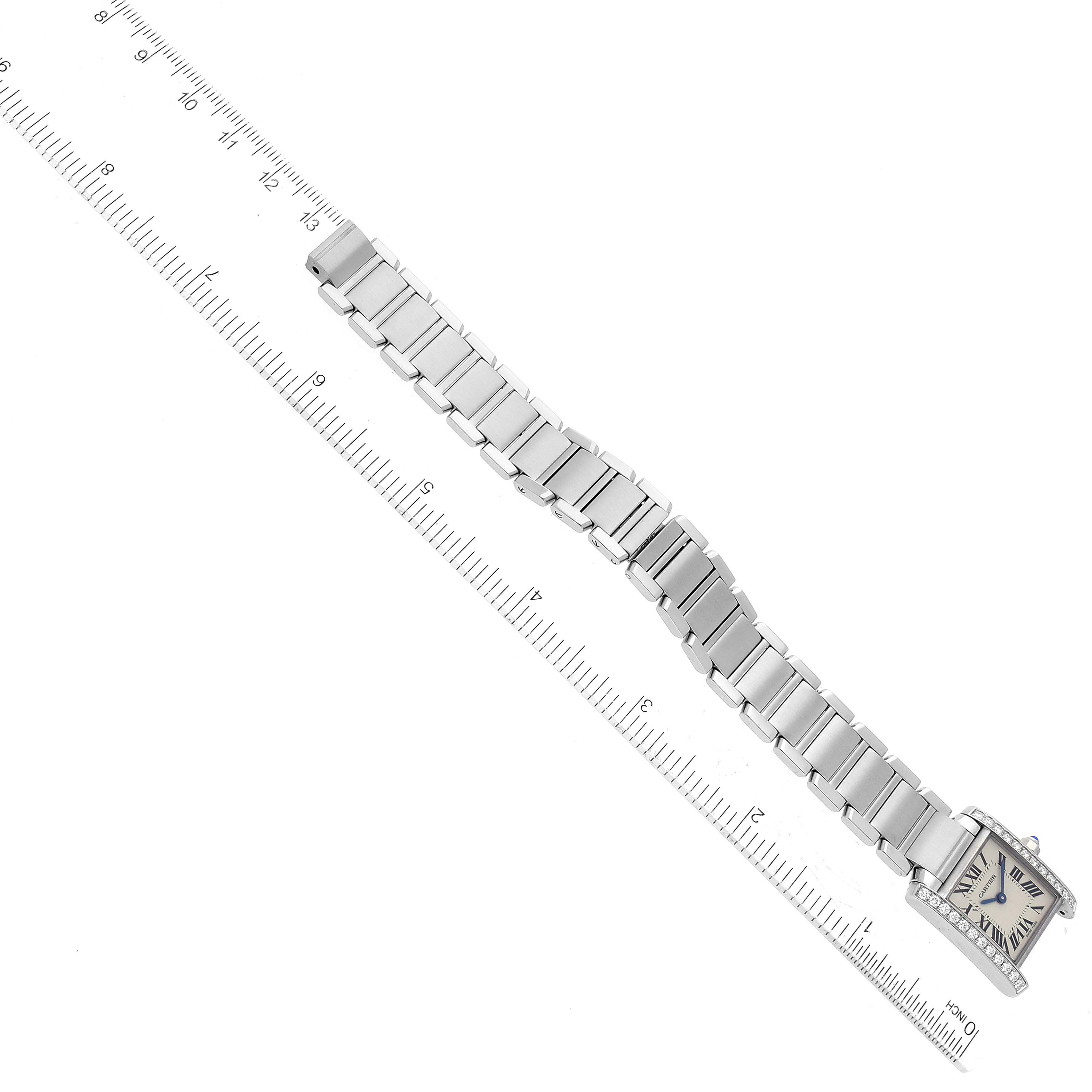 This image shows the entire bracelet and face of the Cartier Tank Française watch, photographed from above with a ruler alongside.