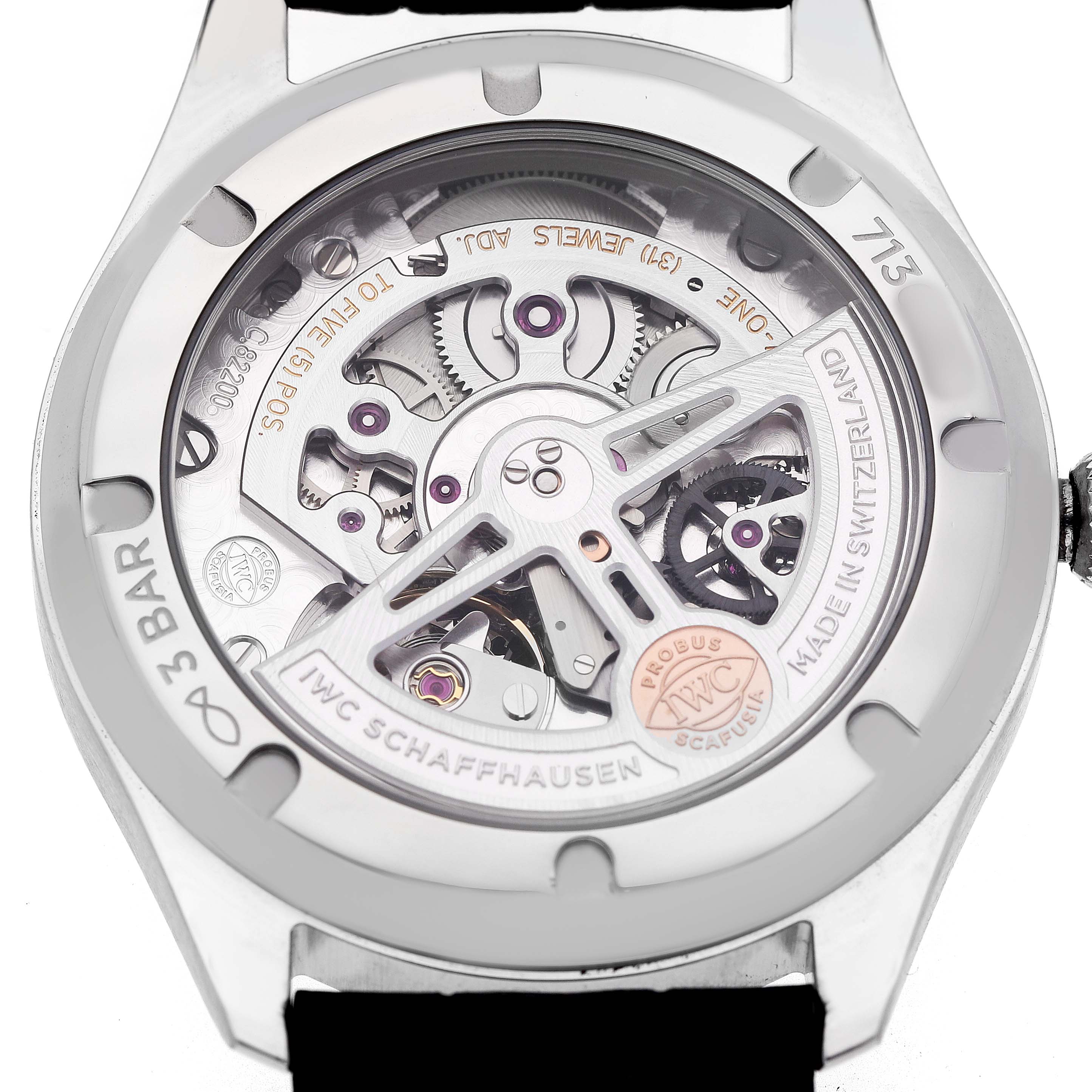 The image shows the case back of an IWC Portuguese IW358303 Men's Stainless Steel Silver Dial watch, highlighting its internal mechanical movement and rotor.