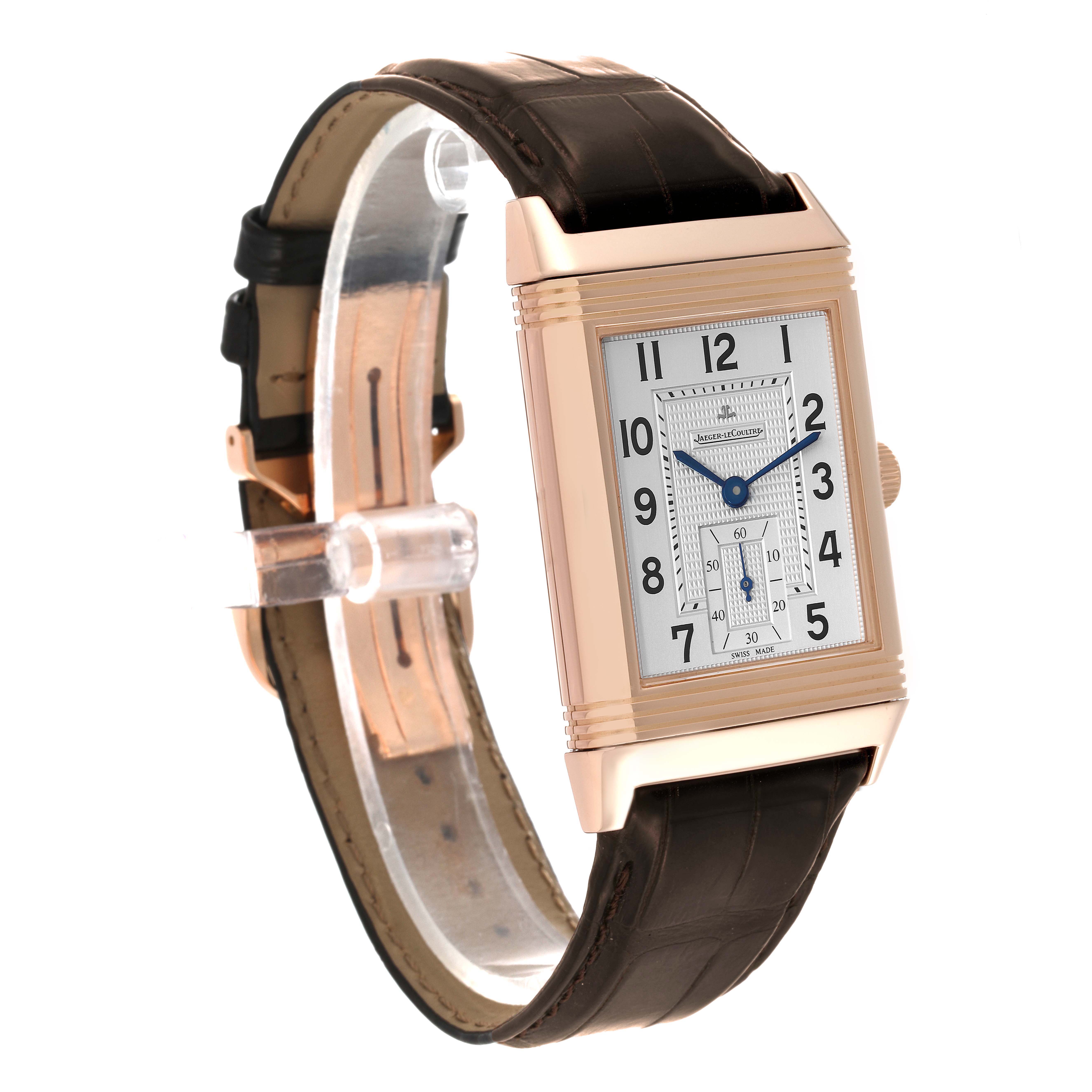 The image shows a Reverso model by Jaeger LeCoultre at a three-quarter angle, showcasing its rectangular face, leather strap, and crown.