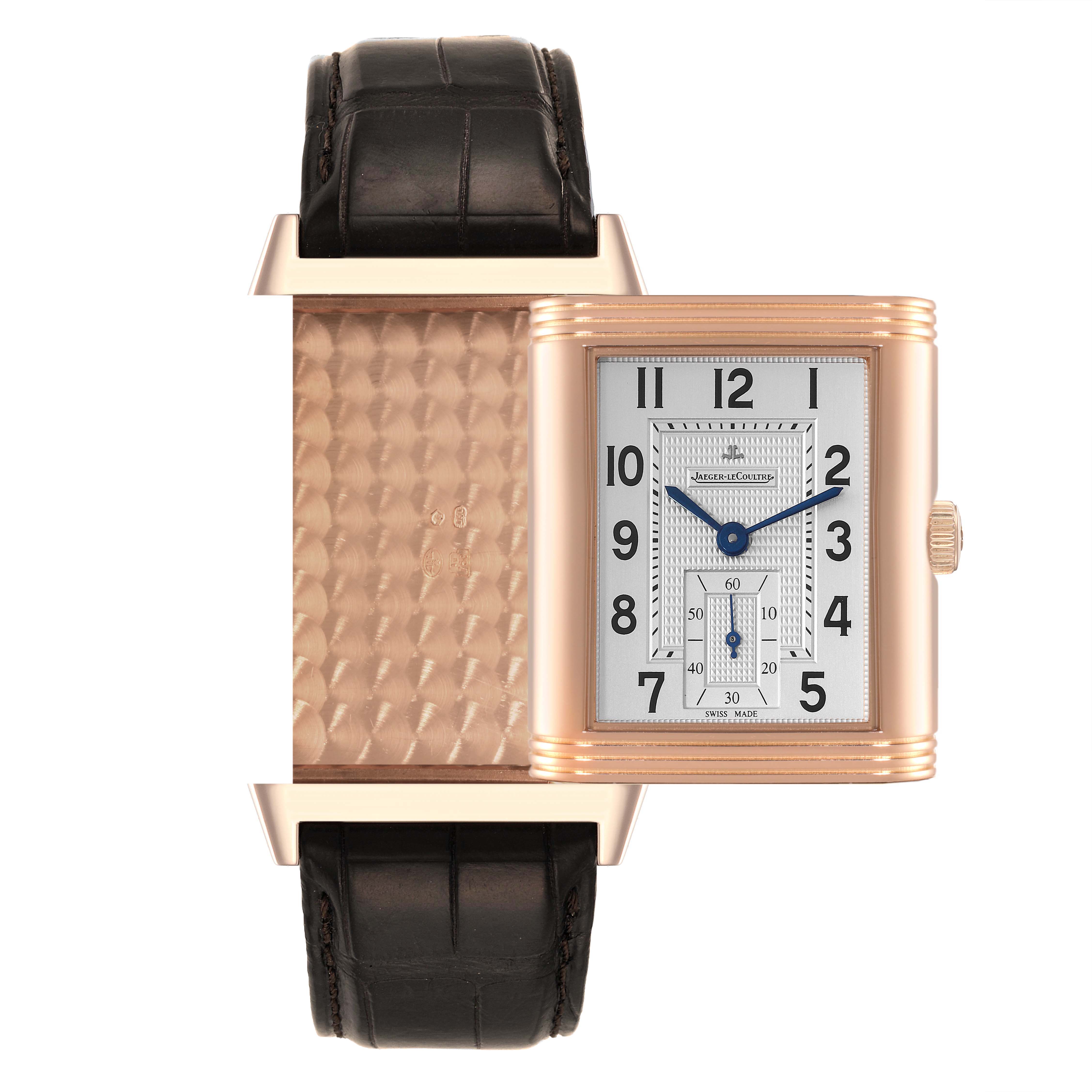 This Jaeger LeCoultre Reverso Q3732420 Men's Rose Gold Silver Dial Q3732420 Men's Rose Gold Silver Dial watch is shown from the front, revealing its face, crown, and partially flipped case back with a patterned detail.