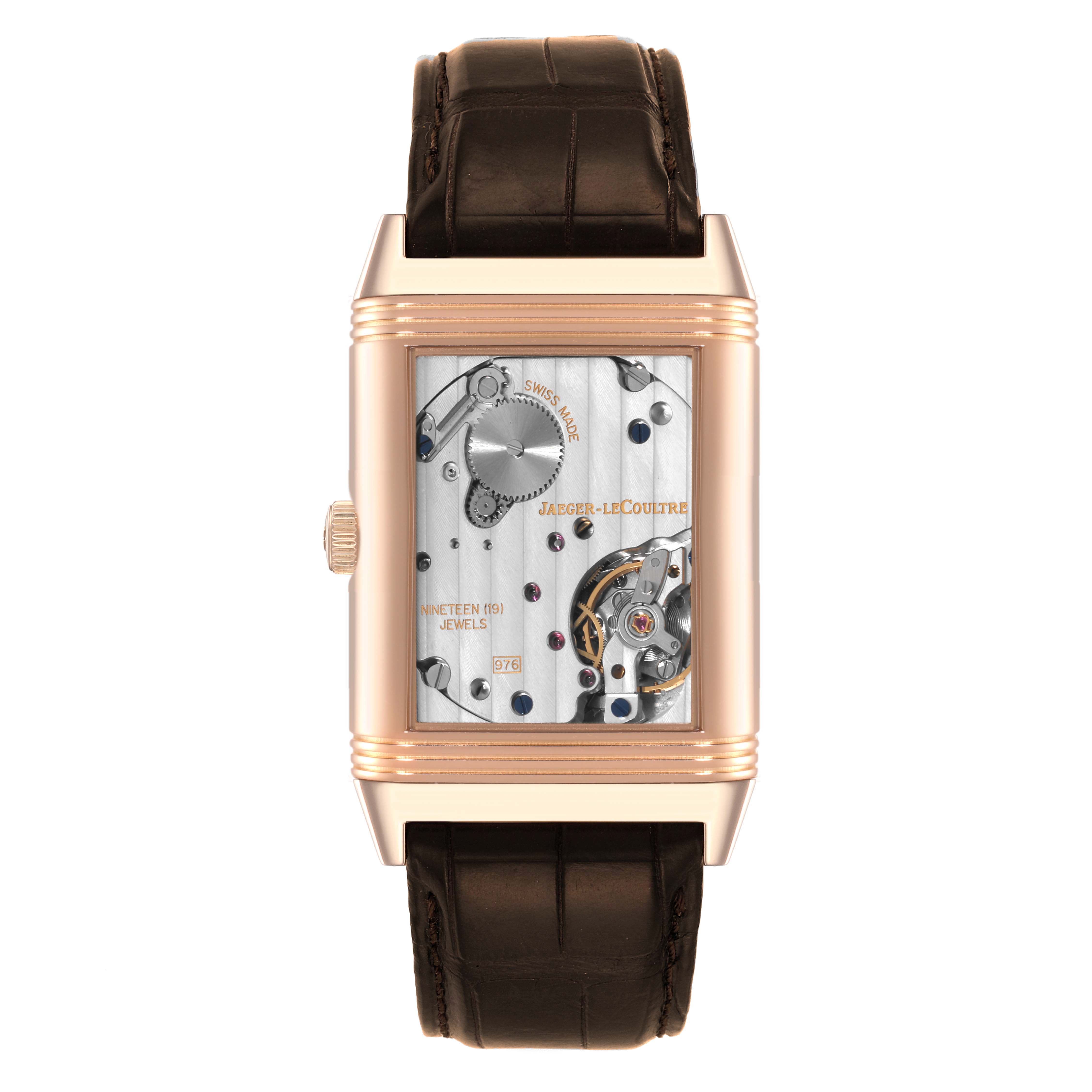 The Jaeger LeCoultre Reverso Q3732420 Men's Rose Gold Silver Dial Q3732420 Men's Rose Gold Silver Dial watch is shown from the front, displaying its mechanical movement and leather strap.