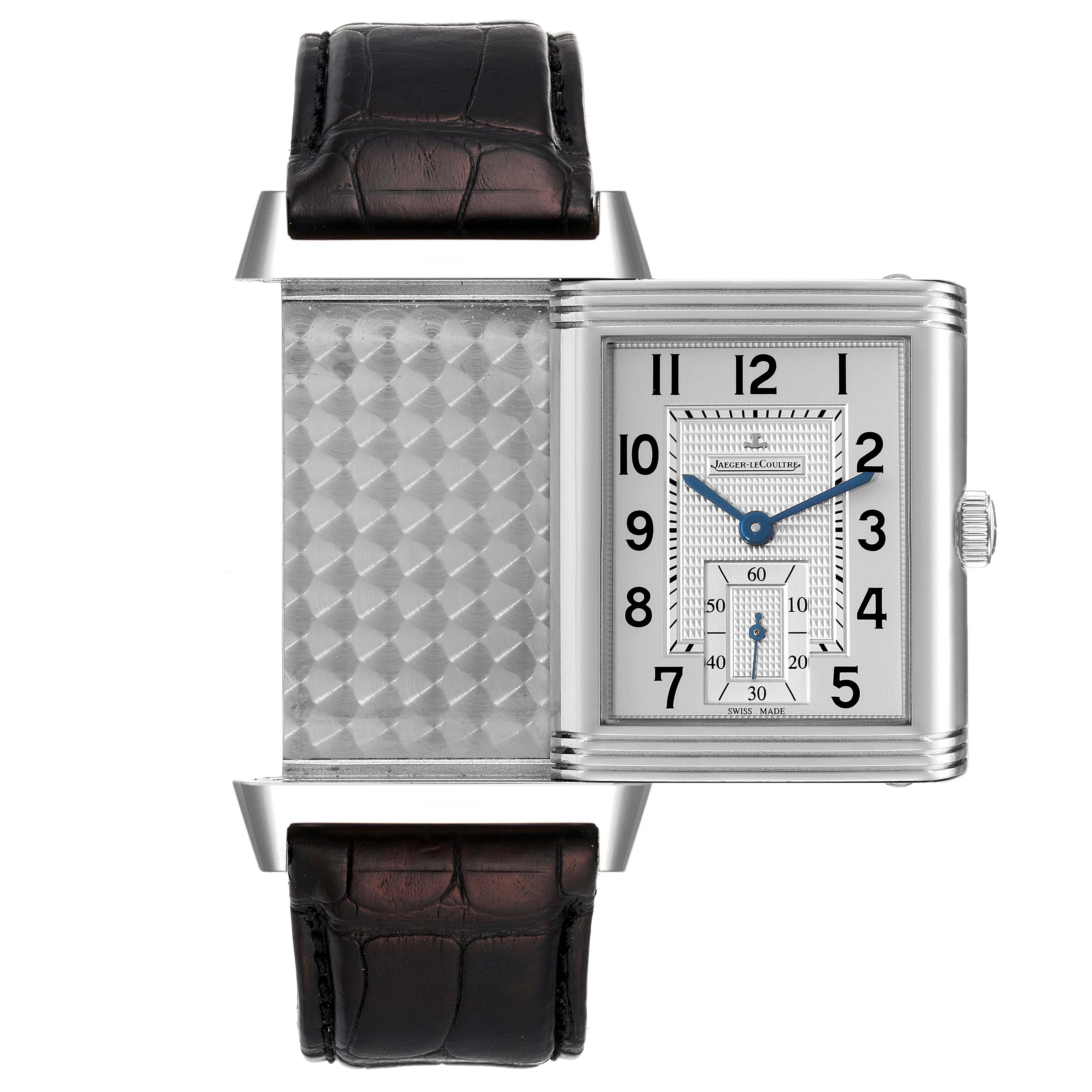 The Jaeger LeCoultre Reverso Q3738420 Men
s Stainless Steel Silver Dial Q3738420 Men
s Stainless Steel Silver Dial watch is shown partially flipped, revealing its patterned back and front dial with a leather strap.