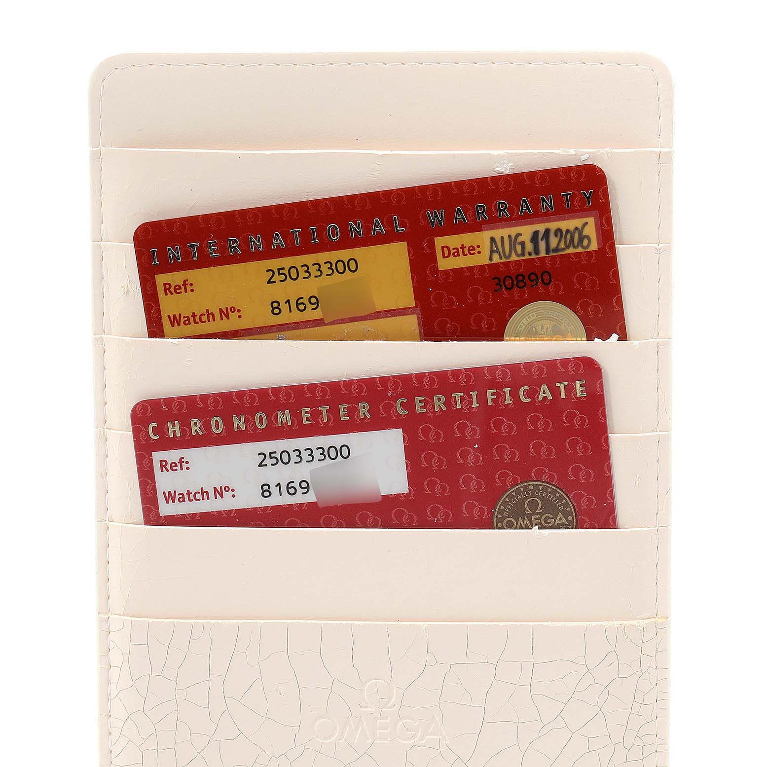 This image shows the International Warranty and Chronometer Certificate cards for the Omega Aqua Terra 2503.33.00 Men's Stainless Steel Silver Dial 2503.33.00 Men's Stainless Steel Silver Dial watch in their holder.