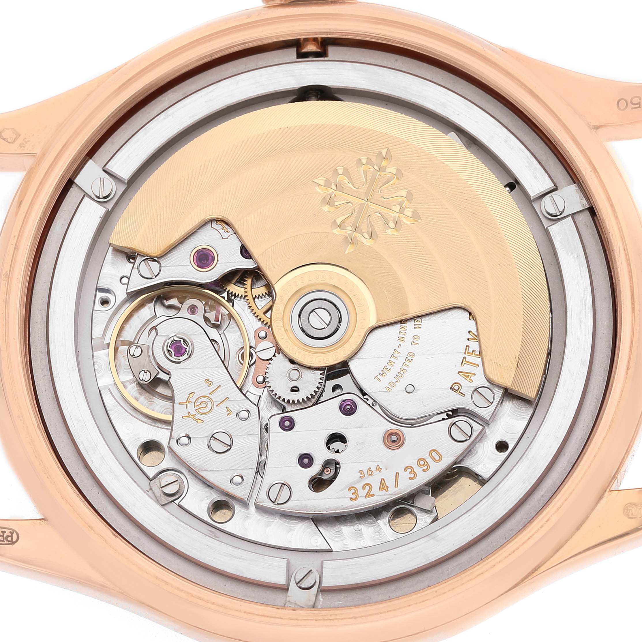 The image shows the movement of a Patek Philippe Calatrava 5296R-001 Men's Rose Gold Silver Dial, viewed from the back, highlighting the rotor and intricate inner workings.