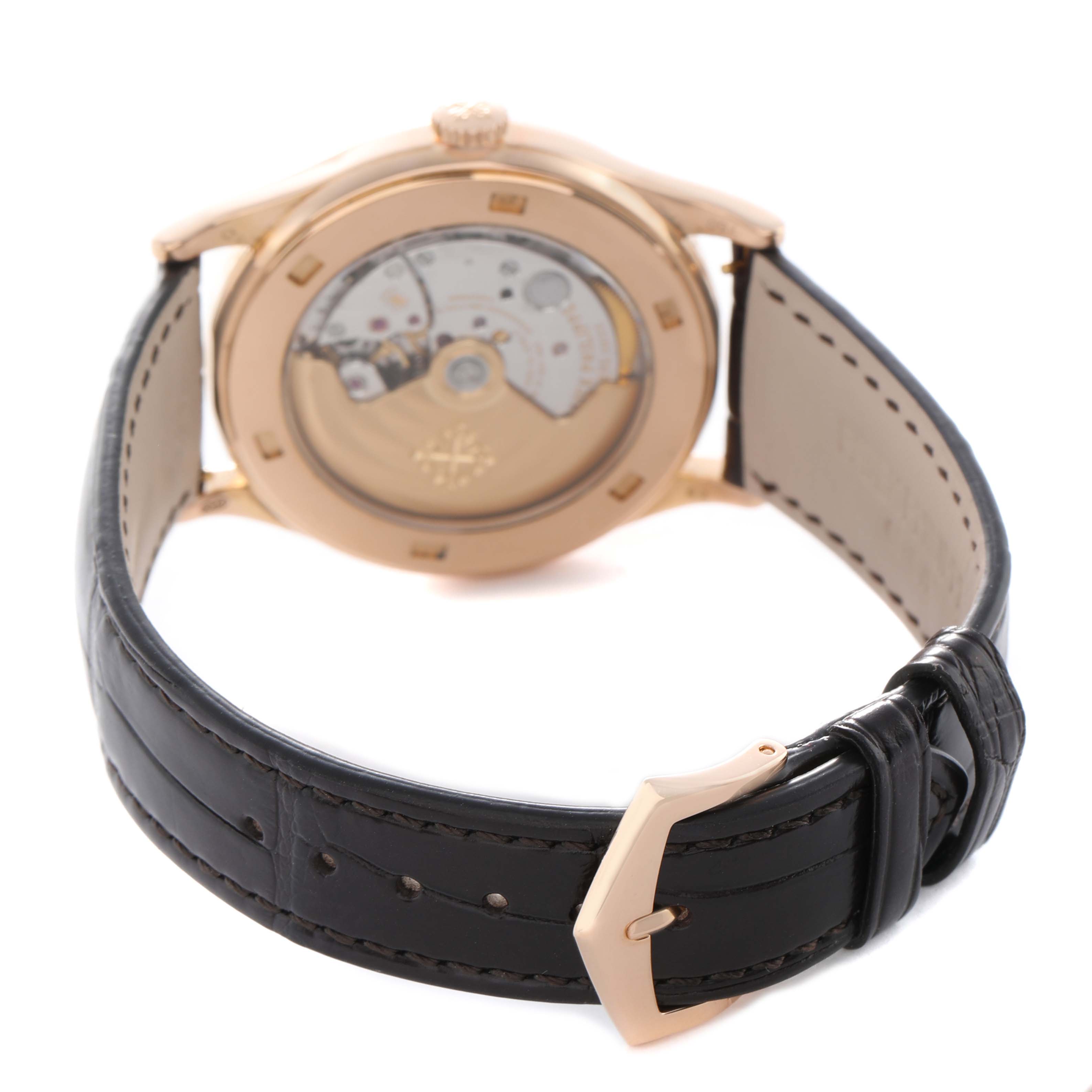 The image shows the back of the Patek Philippe Calatrava 5296R-001 Men's Rose Gold Silver Dial watch, highlighting its movement and leather strap.